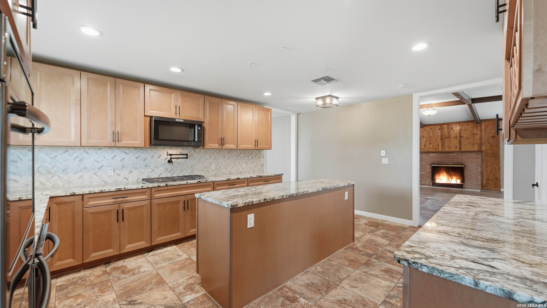 106 County Road 6611 Devine, TX 78016 - Photo 4 of 29 a kitchen with stainless steel appliances granite countertop a sink stove and refrigerator