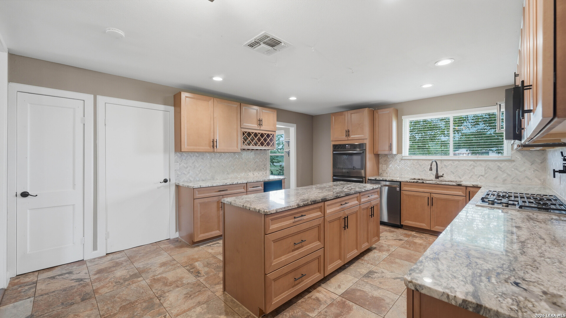 106 County Road 6611 Devine, TX 78016 - Photo 5 of 29 a kitchen with a stove sink and cabinets