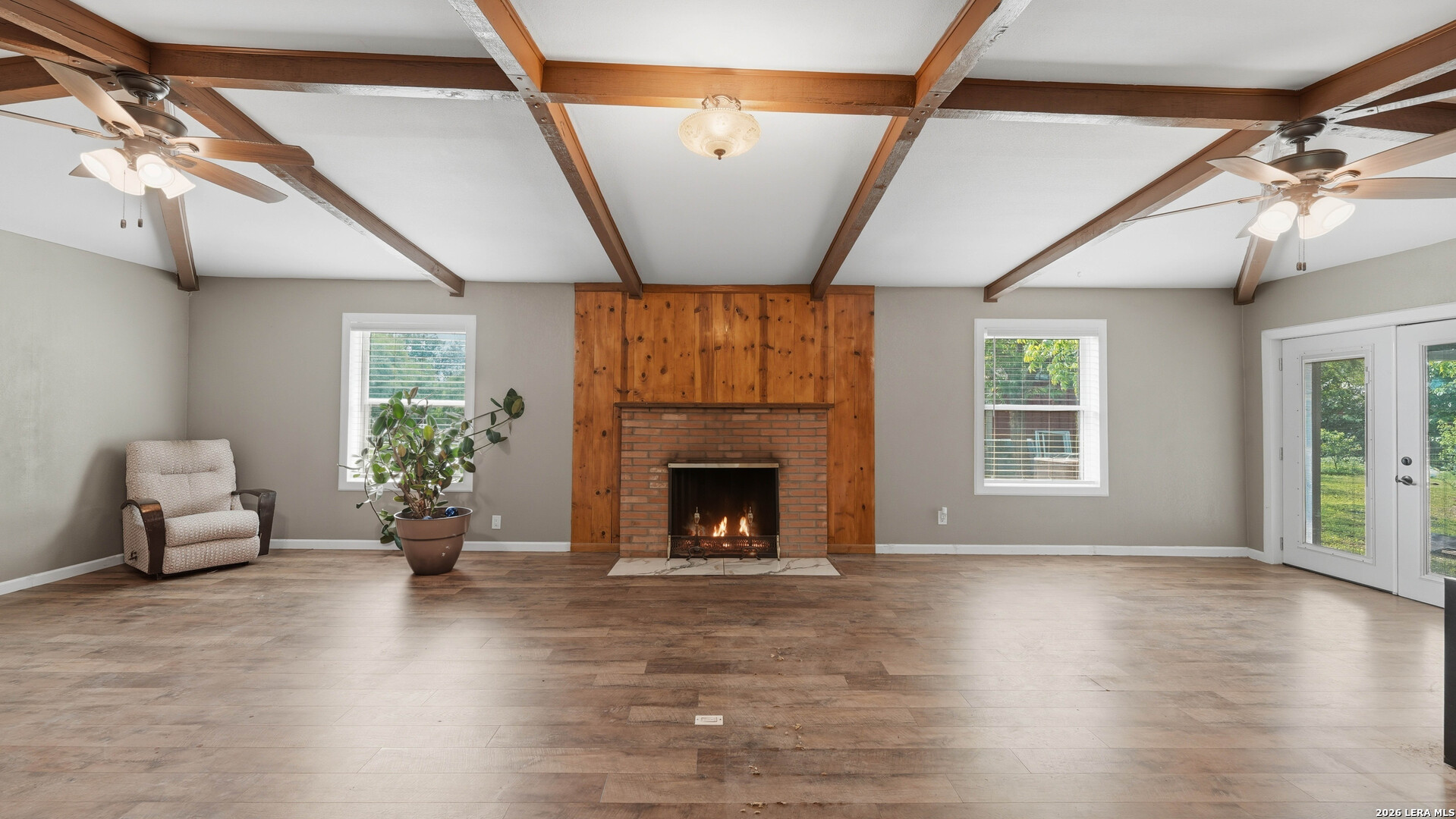 106 County Road 6611 Devine, TX 78016 - Photo 6 of 29 a view of an empty room with wooden floor and a window