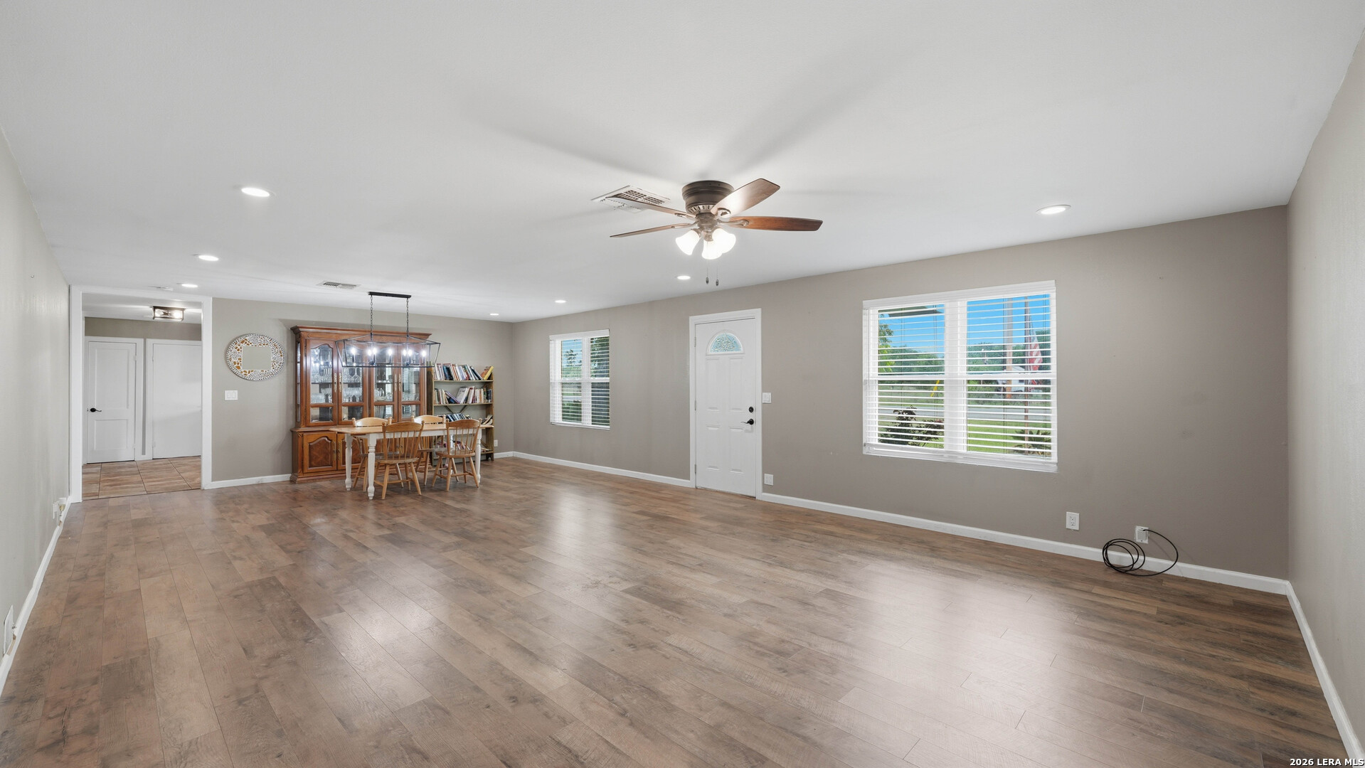 106 County Road 6611 Devine, TX 78016 - Photo 8 of 29 a view of a livingroom with wooden floor and a ceiling fan