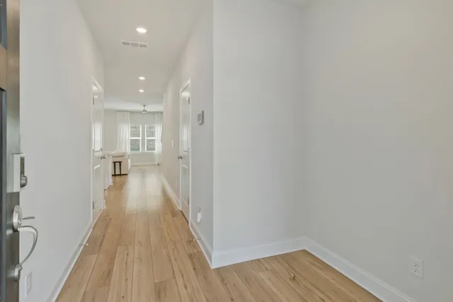 a view of a room with wooden floor