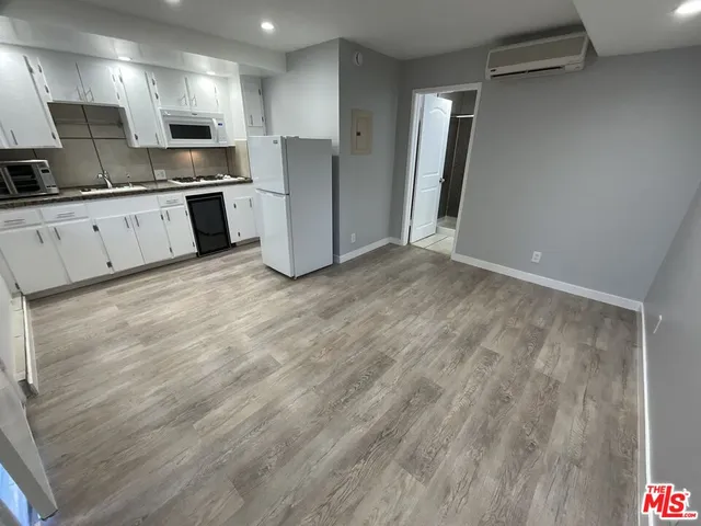 a bathroom with a granite countertop sink toilet and mirror