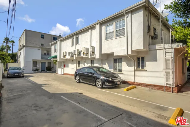 a view of a house with a patio and a yard