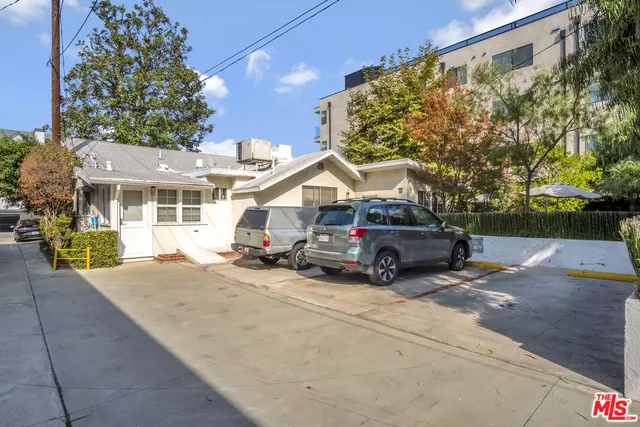 a view of a patio with table and chairs under an umbrella