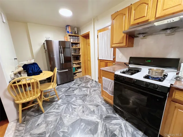 a kitchen with stainless steel appliances granite countertop a stove and a refrigerator