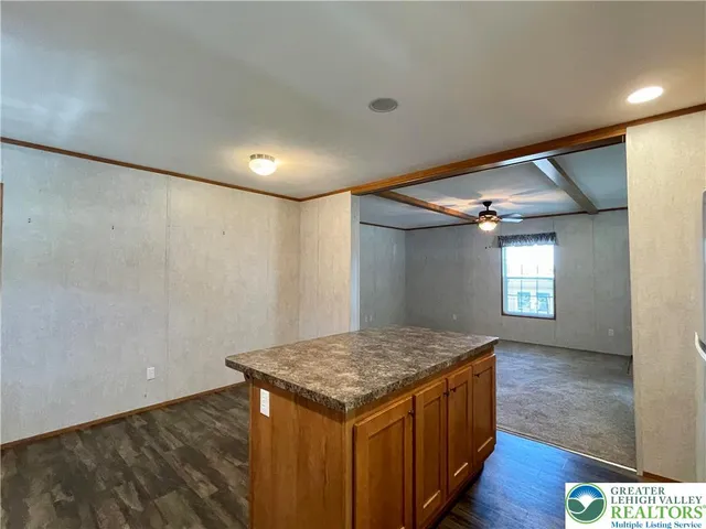 a kitchen with a refrigerator a stove a sink and cabinets