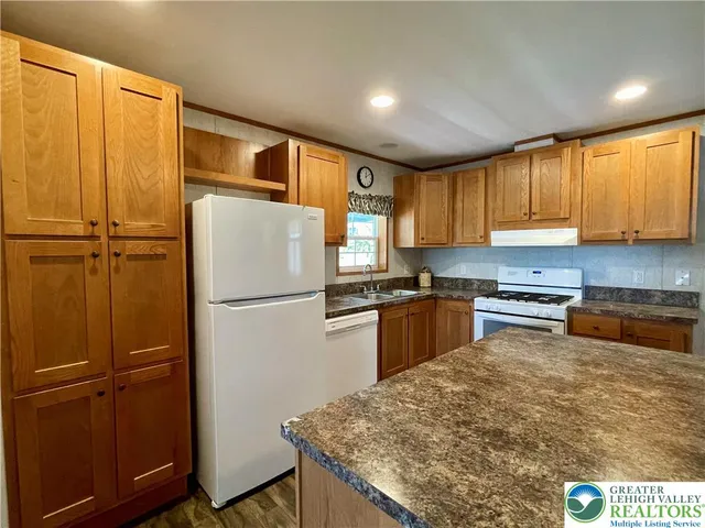 a kitchen with a refrigerator and a sink