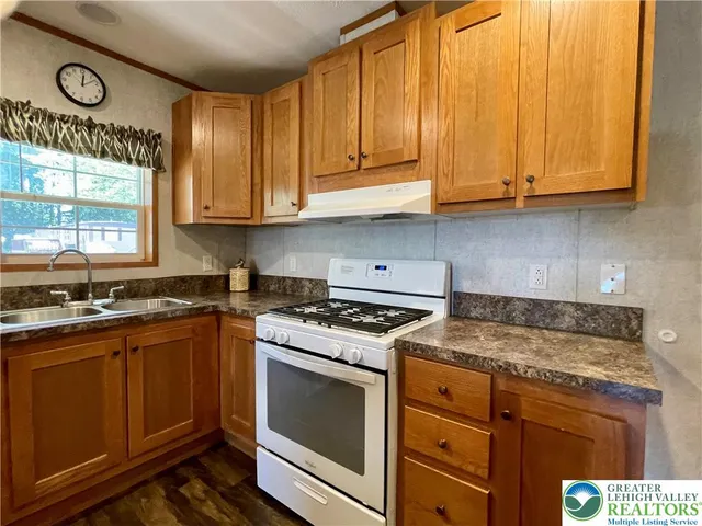 a kitchen with refrigerator and stove