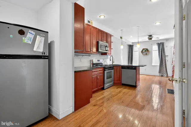 a kitchen with stainless steel appliances granite countertop a refrigerator and a sink