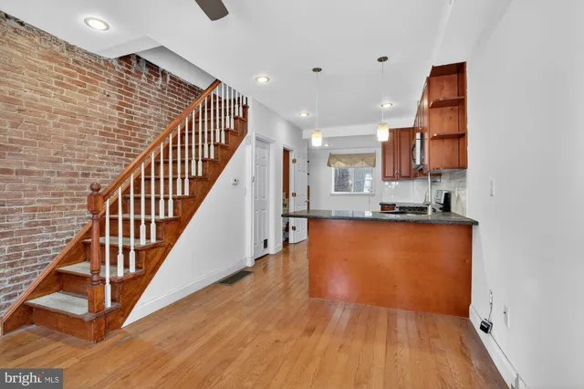 a view of kitchen and hall with wooden floor