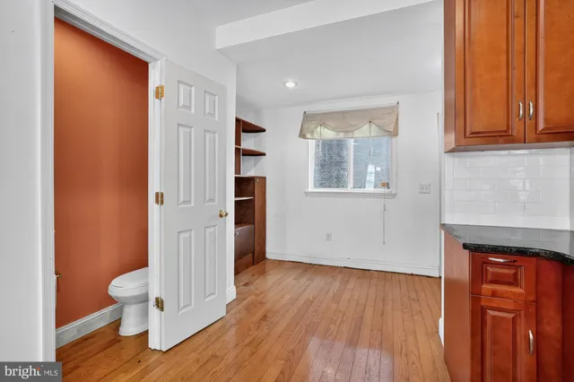 an entryway with wooden floor and a window