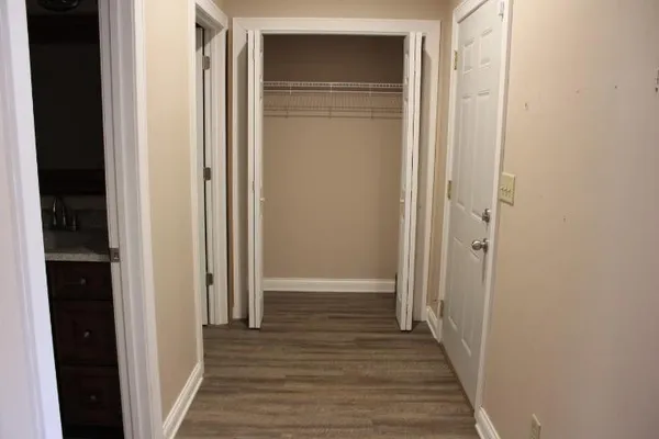 a view of a hallway with wooden floor