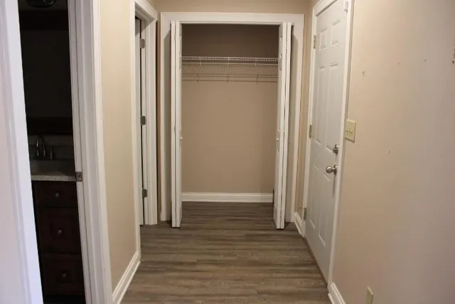 a view of a hallway with wooden floor