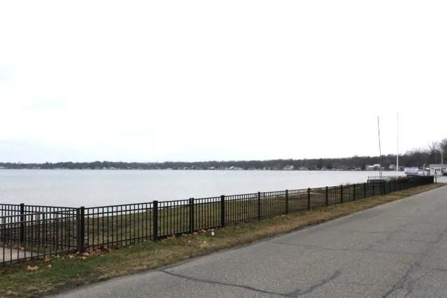 a view of a park with iron fence