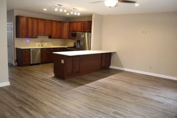 a kitchen with stainless steel appliances granite countertop a sink a stove and a refrigerator