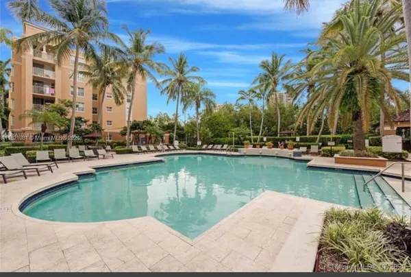 a view of a swimming pool with a lawn chairs