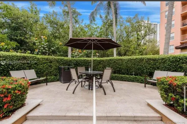 a view of a patio with table and chairs and potted plants