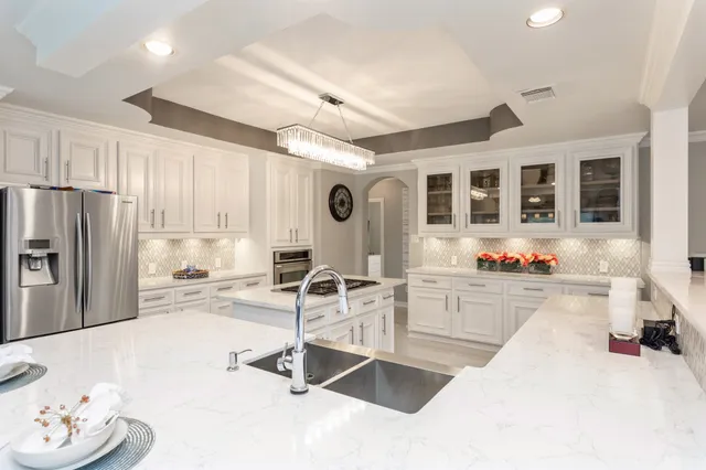 a kitchen with sink refrigerator and microwave