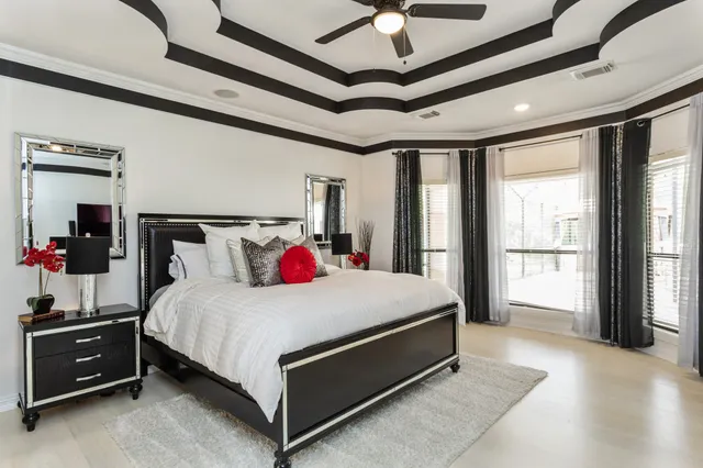 a bed sitting in a bedroom next to a window