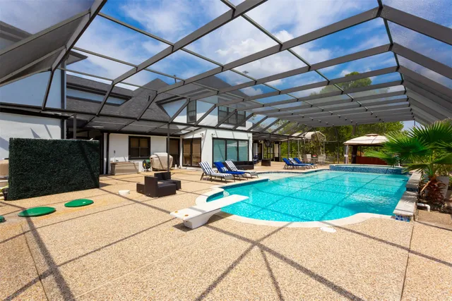 a view of a porch with furniture and garden
