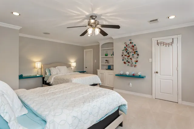 a bedroom with a large bed and a chandelier
