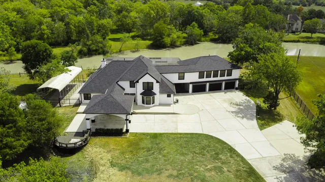 an aerial view of a house with yard swimming pool and outdoor seating
