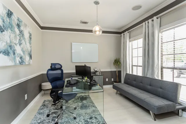 a living room with furniture fireplace and a window