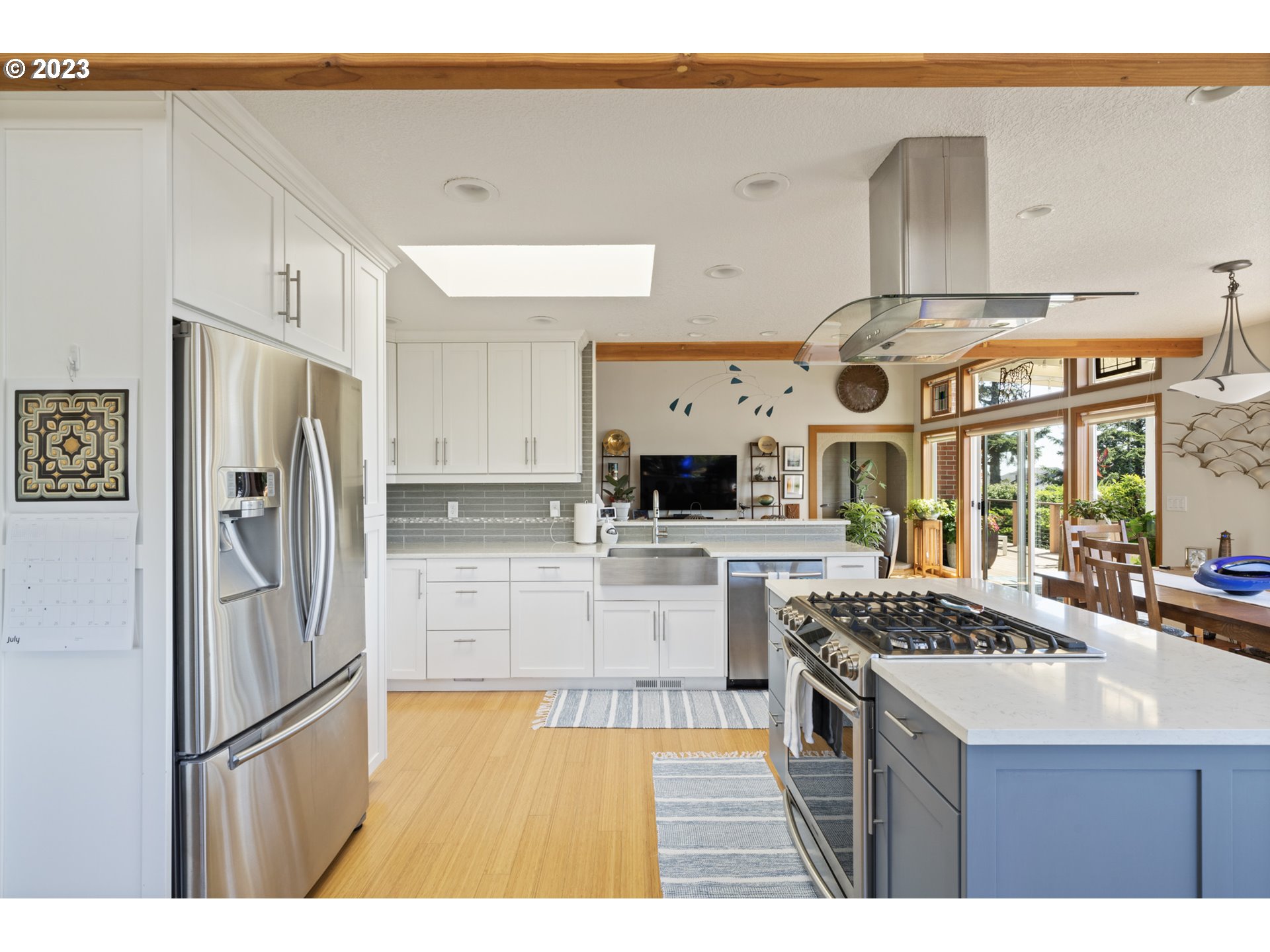 905 Pinewood West Tillamook, OR 97141 - Photo 13 of 44 a kitchen with stainless steel appliances a refrigerator a stove and white cabinets