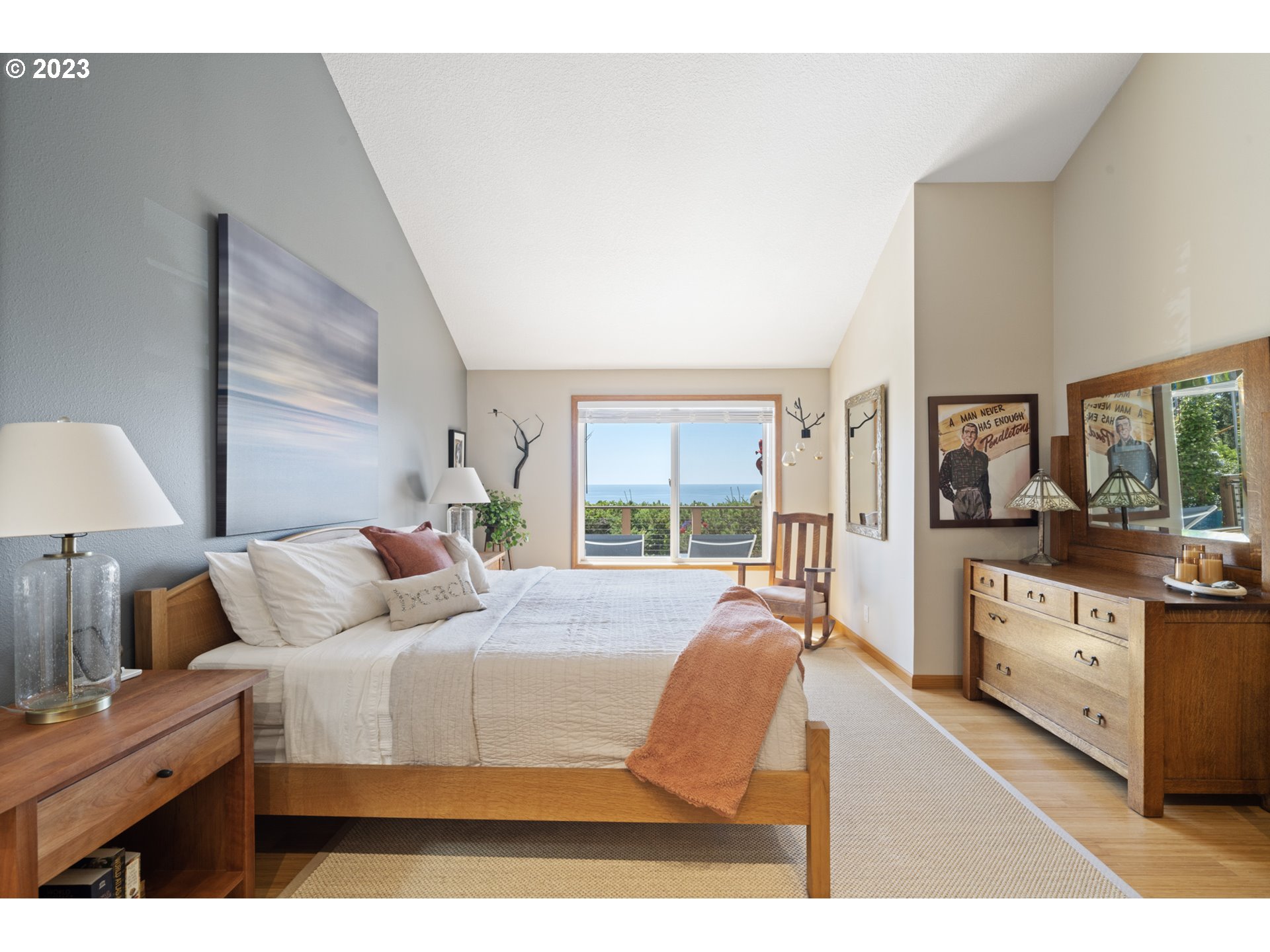 905 Pinewood West Tillamook, OR 97141 - Photo 19 of 44 a bedroom with a bed and large windows