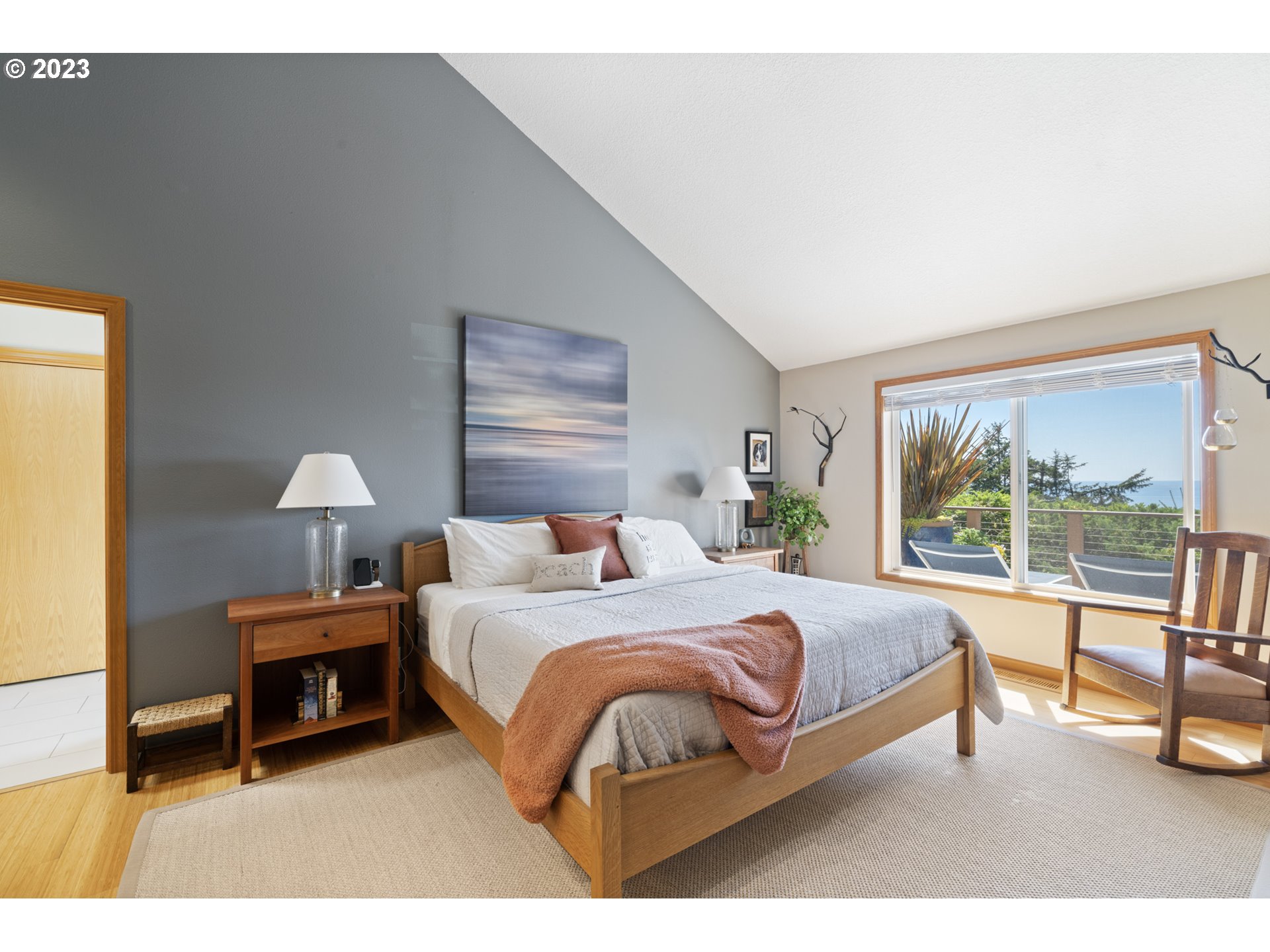 905 Pinewood West Tillamook, OR 97141 - Photo 20 of 44 a bedroom with a bed lamp and window