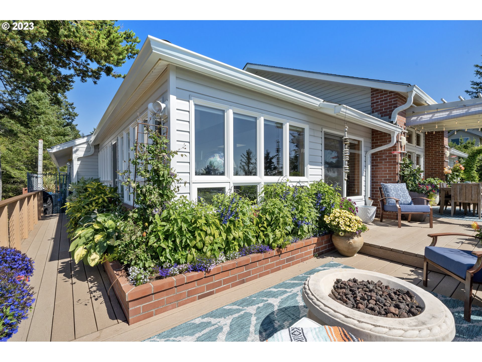 905 Pinewood West Tillamook, OR 97141 - Photo 26 of 44 a view of a patio with couches table and chairs and potted plants