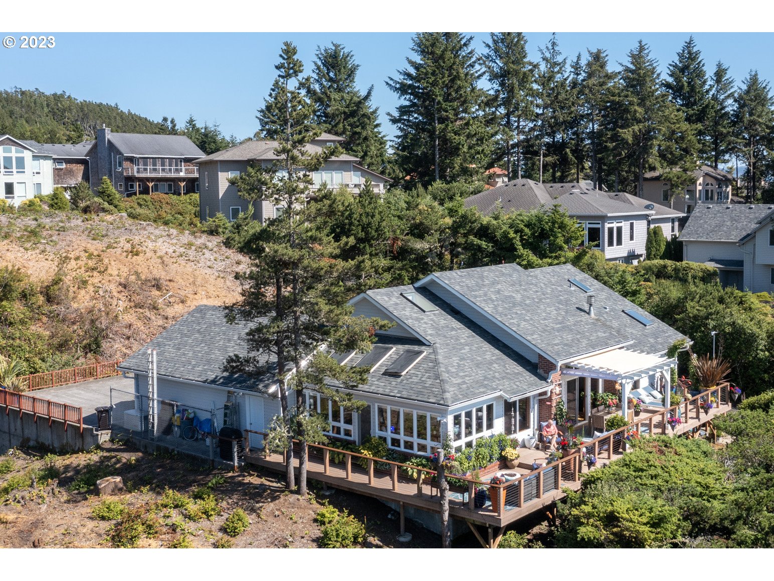 905 Pinewood West Tillamook, OR 97141 - Photo 4 of 44 a aerial view of a house next to a yard