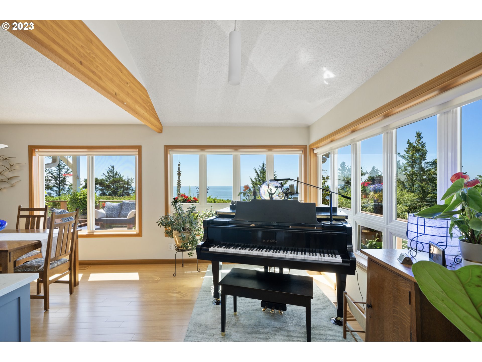 905 Pinewood West Tillamook, OR 97141 - Photo 8 of 44 a living room with furniture a dining table and a large window