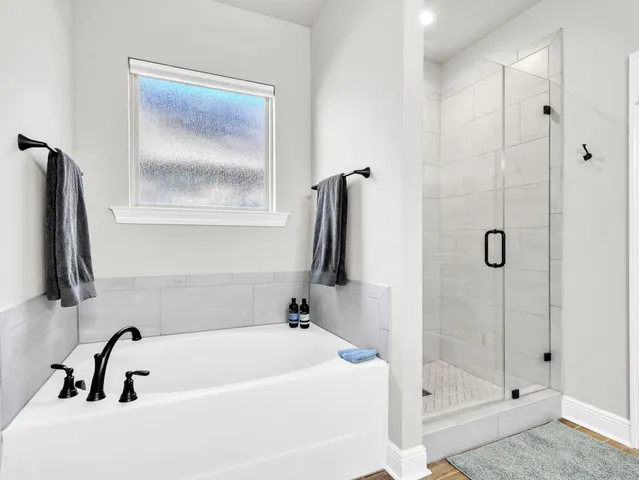 a living room with furniture large window and wooden floor