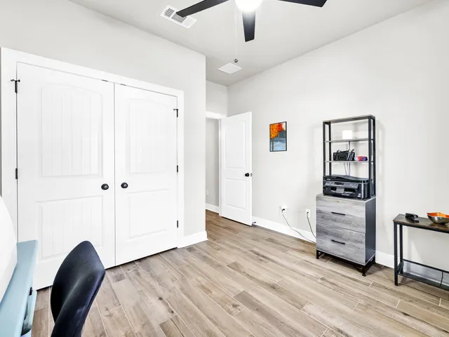 a view of a swimming pool with a yard and plants