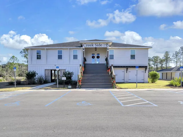 a view of a swimming pool with outdoor seating