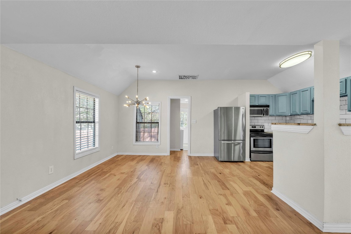 2403 South 3rd Street Austin, TX 78704 - Photo 12 of 29 a kitchen with stainless steel appliances a refrigerator and wooden floor