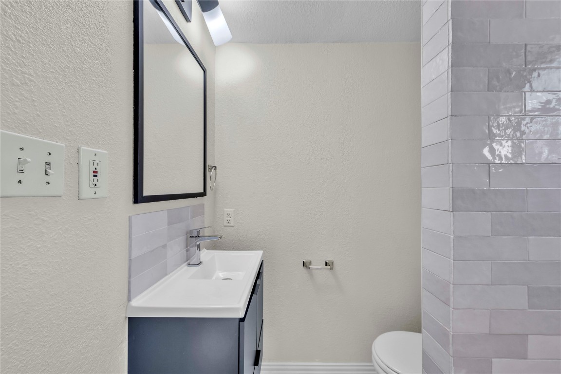 2403 South 3rd Street Austin, TX 78704 - Photo 13 of 29 a bathroom with a sink a toilet and mirror