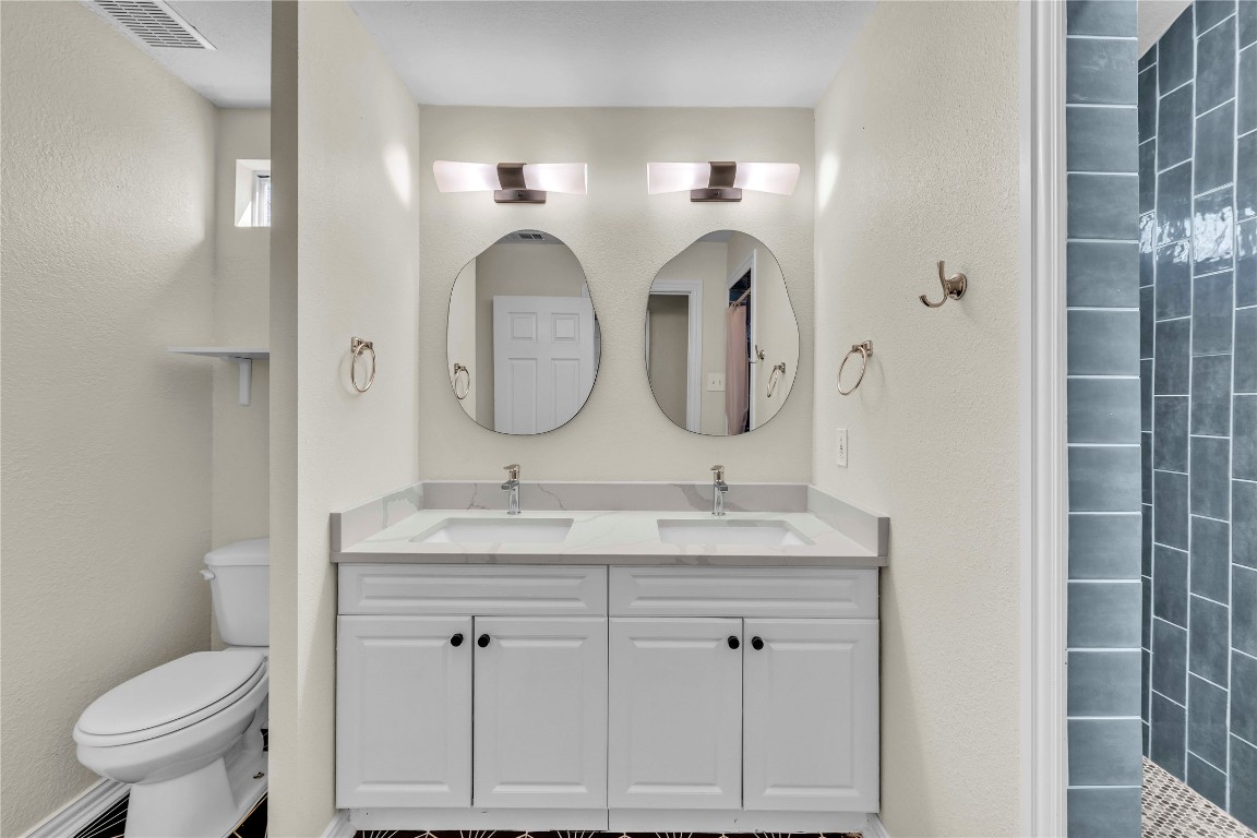 2403 South 3rd Street Austin, TX 78704 - Photo 18 of 29 a bathroom with double vanity sink and two mirror