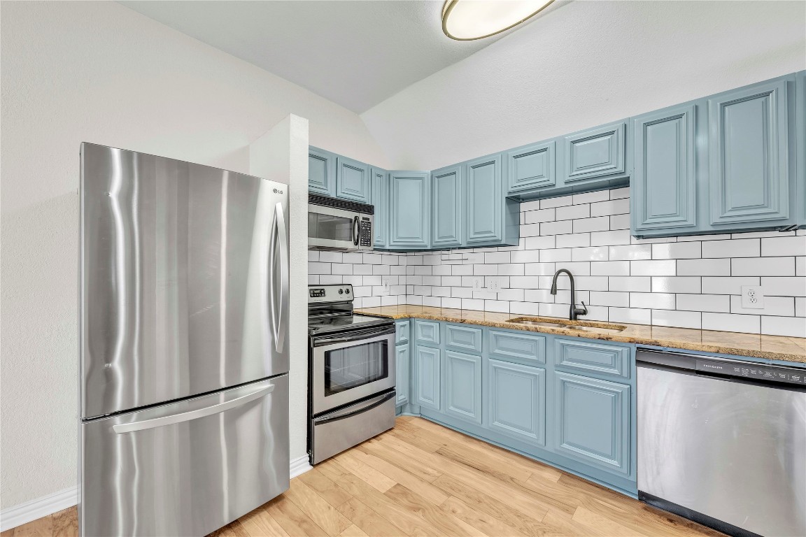 2403 South 3rd Street Austin, TX 78704 - Photo 2 of 29 a kitchen with stainless steel appliances granite countertop a refrigerator sink and stove