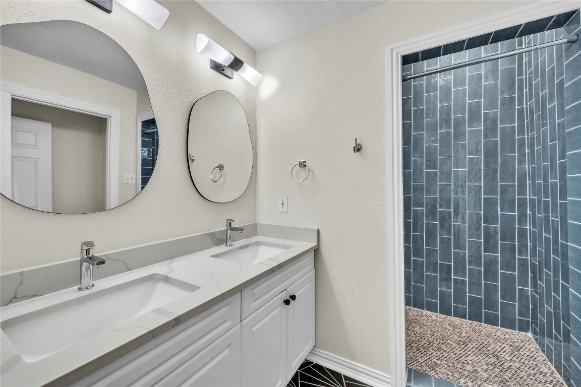2403 South 3rd Street Austin, TX 78704 - Photo 3 of 29 a bathroom with a double vanity sink mirror and shower