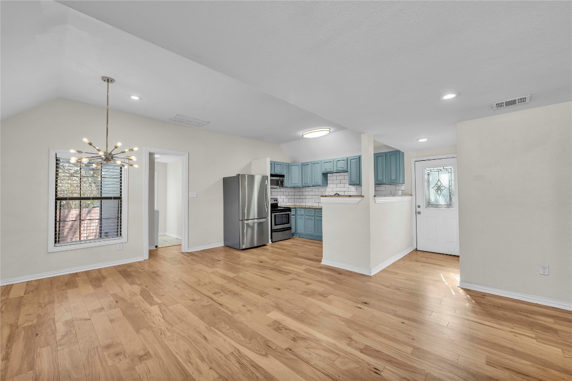 2403 South 3rd Street Austin, TX 78704 - Photo 28 of 29 a view of a kitchen with a sink wooden floor kitchen view and a refrigerator