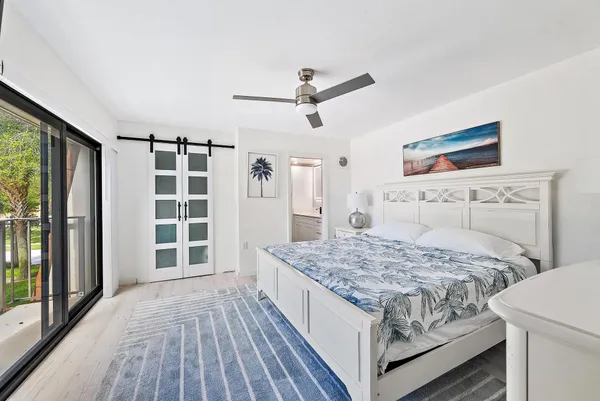 a bedroom with a large bed and a window