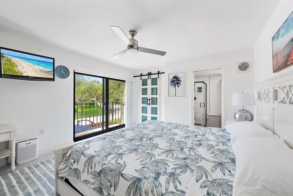 a bedroom with a large bed and a large window