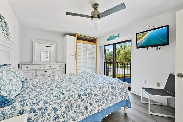 a bedroom with a large bed and a chair