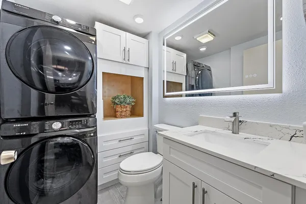 a bathroom with a sink a washer and dryer