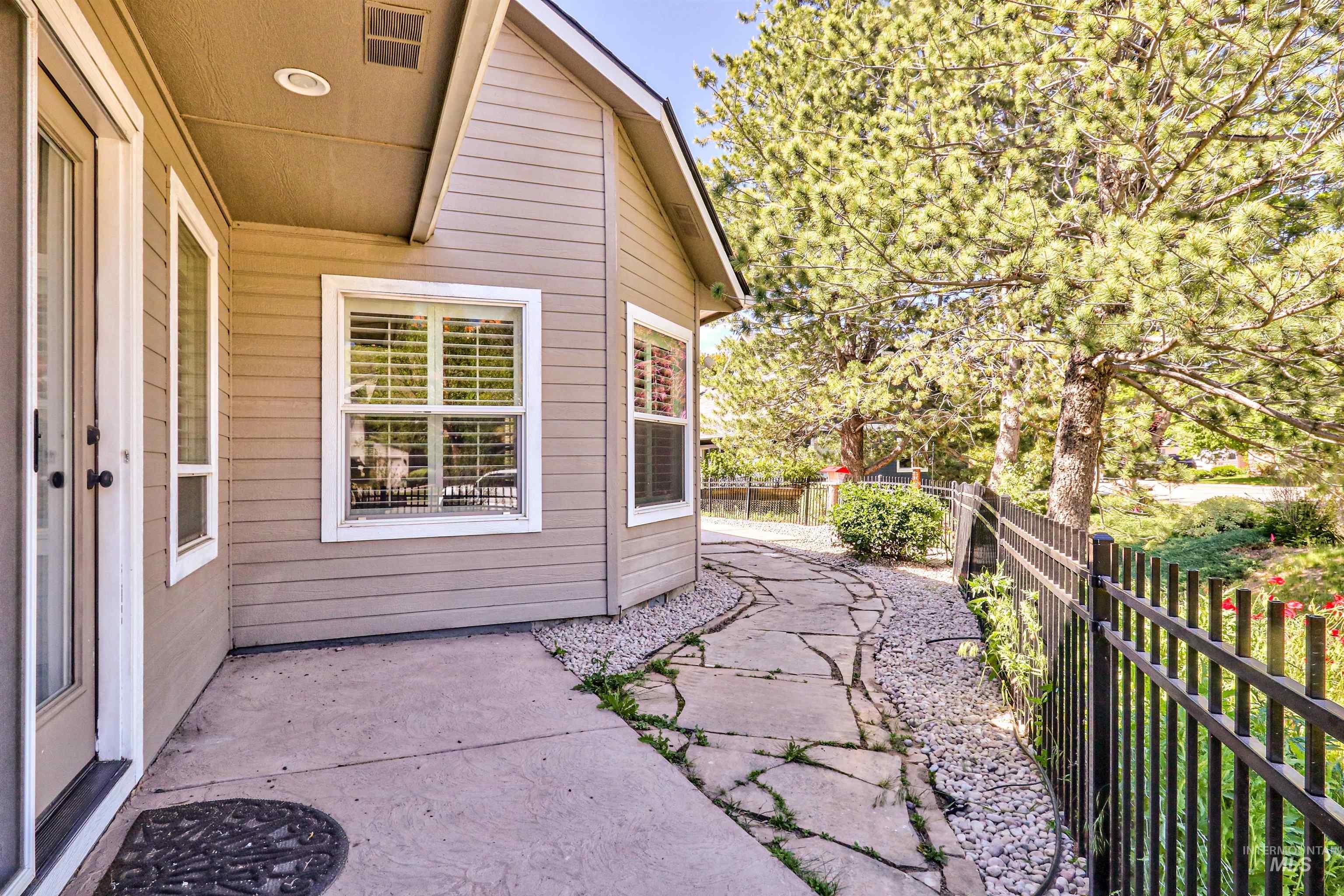 892 South Capitola Way Boise, ID 83712 - Photo 30 of 34 Exterior wall with horizontal siding, multiple windows with white trim, and a full-light entry door