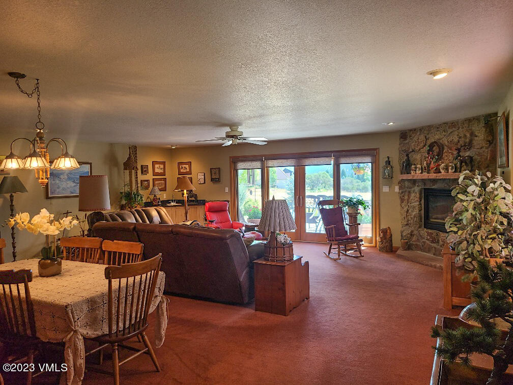 1072 Mesa Drive Eagle, CO 81631 - Photo 13 of 34 a living room with fireplace furniture and a large window