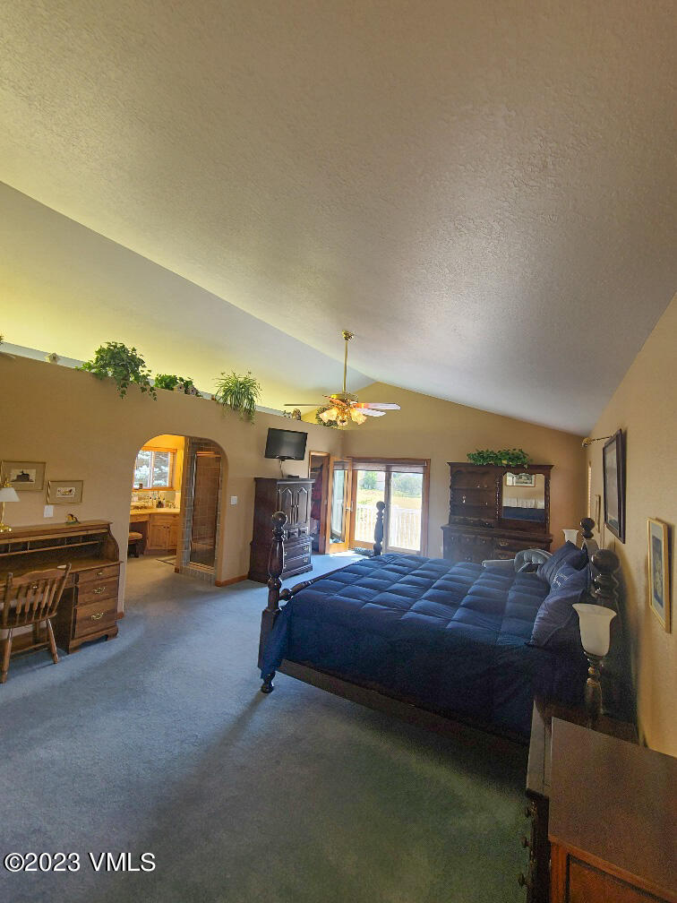 1072 Mesa Drive Eagle, CO 81631 - Photo 25 of 34 a bedroom with furniture and a chandelier