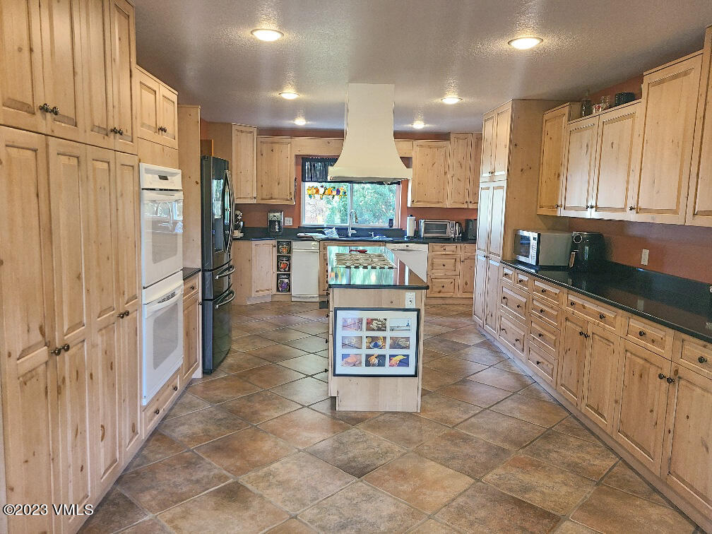1072 Mesa Drive Eagle, CO 81631 - Photo 3 of 34 a kitchen with stainless steel appliances granite countertop a refrigerator oven stove a sink and a refrigerator